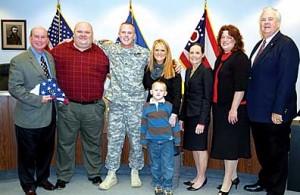 Sergeant Chris Schoumacher of the Army National Guard was honored for his service in Iraq once he returned to Clermont County. From left are Commissioner Bob Proud, Frank Morrow of the Veterans’ Service Commission, Schoumacher with his wife Kristin and oldest son Carter, Congresswoman Jean Schmidt, Tracy Braden of The Thank-You Foundation and Commissioner Ed Humphrey.
